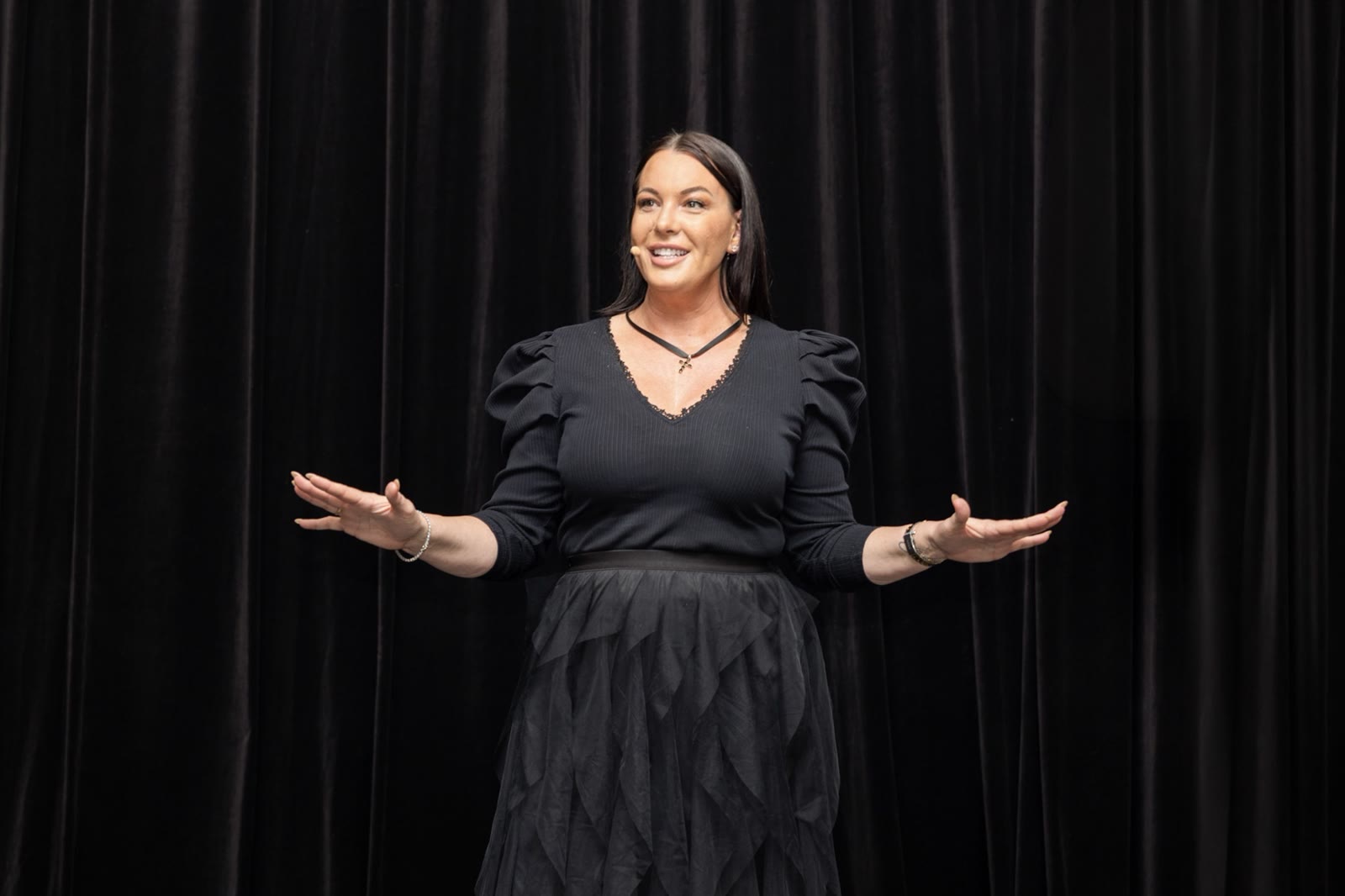 Vanessa Bellden speaking on stage at Confab